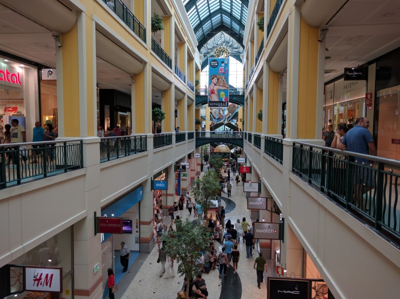 day, people, built structure, outdoors, shopping mall, architectural column, incidental people, large group of people, real people, Mall, adult, railing