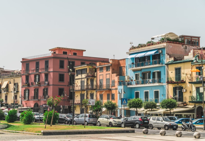 outdoors, car, orange, road, italy, seafront, windows, roofs, red, building, residential district, balconies, tree, palaces, motor vehicle, cityscape, incidental people