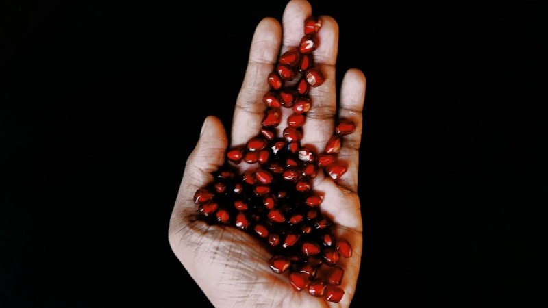human hand, indoors, hand, studio shot, copy space, 4K, pomegranate, one person, holding, human body part, body part, black background, love, luck, human