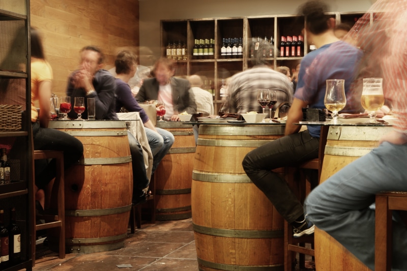 food, women, spanish, room, alcohol, barrels, glass, tables, eating, beer, men, sitting, wine, barrel, snacks, restaurant, food and drink industry, tiles