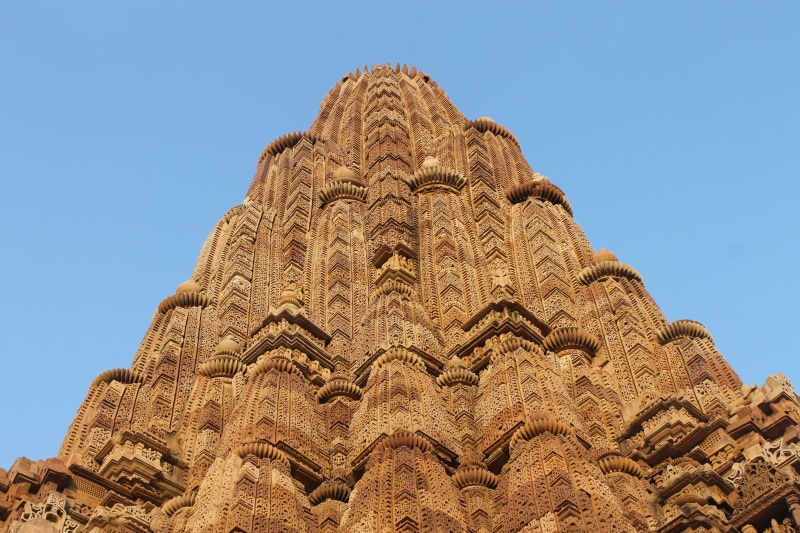 spirituality, sky, craft, sandstone, blue, low angle view, temple, clear sky, stone, nature, old, tourism, architecture, carving - craft product, outdoors