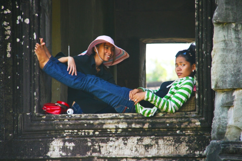 lying, temple, people smiling, females, bonding, childhood, innocence, boys, casual clothing, expression, day, laos, asian girl, men, lifestyles, togetherness