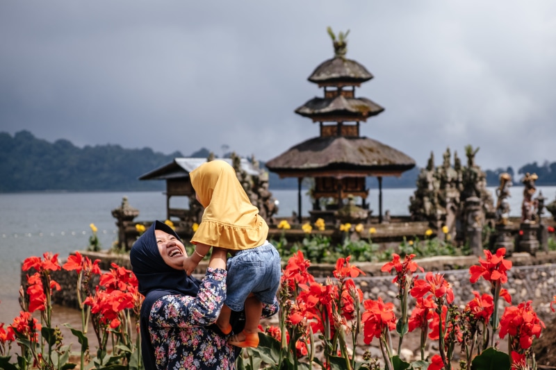 togetherness, plant, leisure activity, lifestyles, temple, woman, carrying, flower arrangement, water, blossom, person, hijab, flower, black, tulip, adult