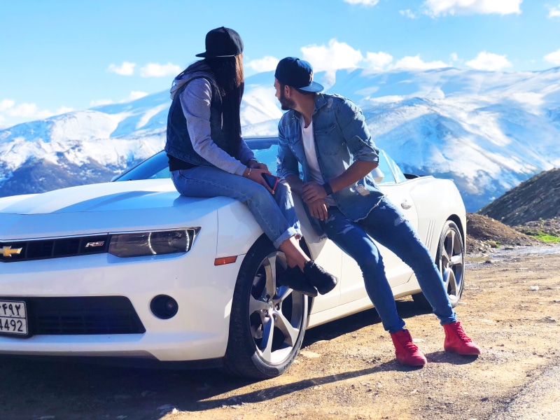 near, vehicle, snow, standing, couple - relationship, mountain range, man, car, white, chevrolet, young adult, snowcapped mountain, lifestyles, camaro