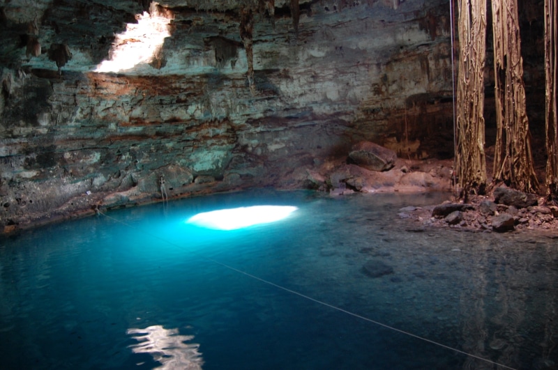 cenote, tranquil scene, nature, cavern, geology, yucatan, reflection, majestic, solid, inside, beauty in nature, cave, illuminated, outdoors, no people