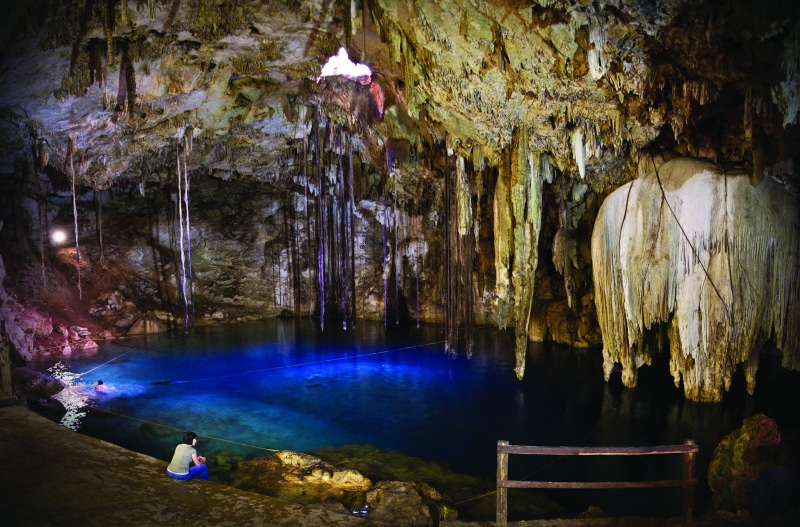 beauty in nature, real people, indoors, nature, solid, water, adult, women, leisure activity, rear view, illuminated, 2K, cave, person, one person, stalactite