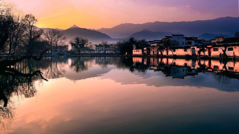 cloud - sky, mountain range, water, sky, beauty in nature, anhui, built structure, travel destinations, townlet, hongcun ancient village, hongcunzhen, tranquil scene