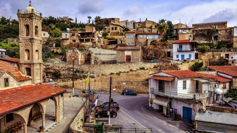 town, facade, built structure, land vehicle, outdoors, tourism, sky, motor vehicle, residential district, building exterior, neighbourhood, street, city
