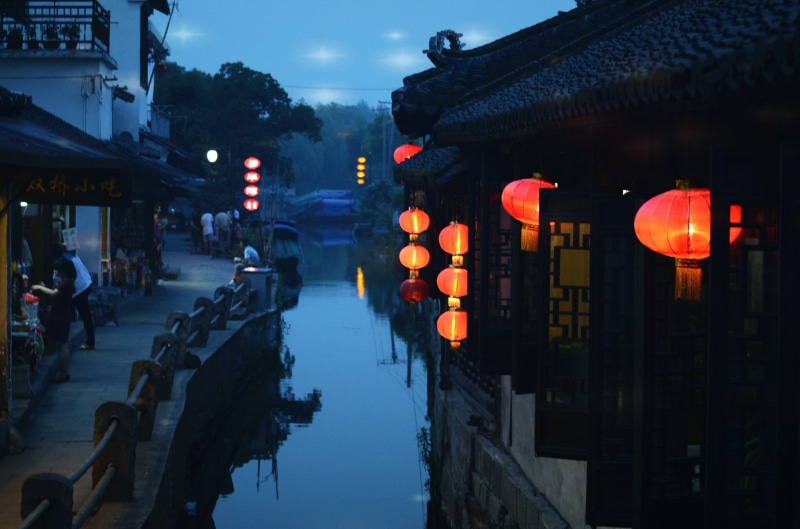 illuminated, dusk, the ancient town, chinese lantern festival, nature, incidental people, lighting equipment, lantern, black, group of people, building exterior