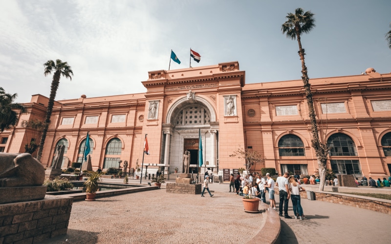 office building, town, historic, building, person, history, arch, street, arecaceae, lifestyle, outdoors, built structure, museum, nature, palm tree, day