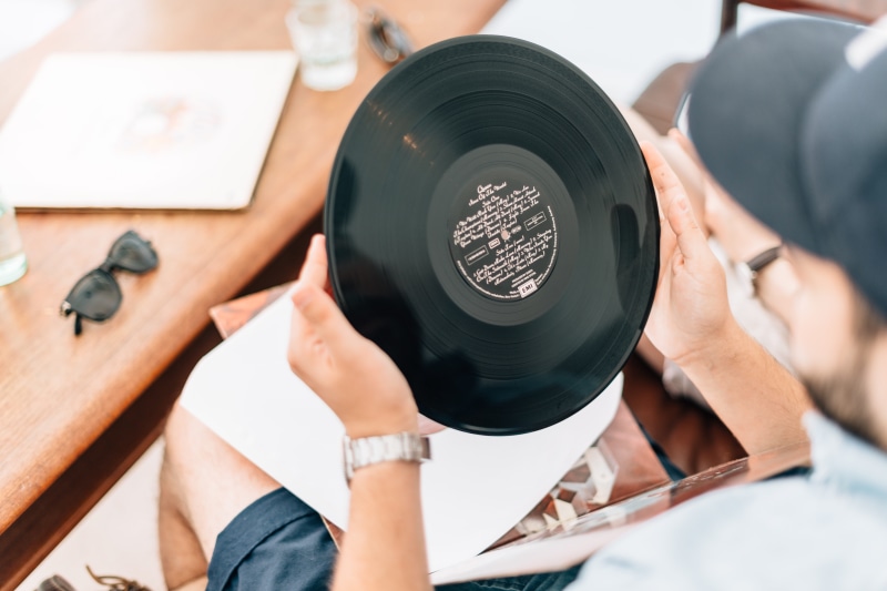 player, holding, record player, man, vinyl, close-up, wireless technology, music, man in white, technology, hand, adults only, occupation, young men, two people