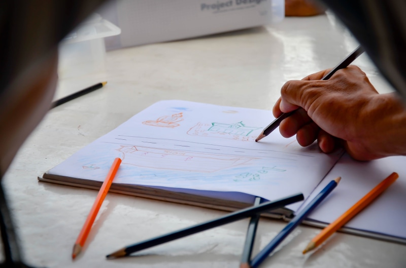 art and craft, concept, human, handwriting, ink, pen, hand, artist, presentation, symbol, whiteboard, table, one person, sketch, text, illustration, write