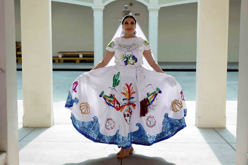 looking at camera, standing, wooden, ornament, outdoors, latin, day, tradition, costume, heritage, tijuana, eyes, young women, women, one person, surface