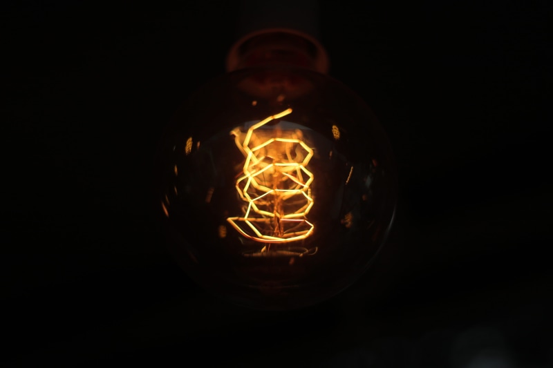 domestic room, filament, illuminated, pakistan, dark, glass - material, yellow, light - natural phenomenon, black background, indoors, fuel and power generation