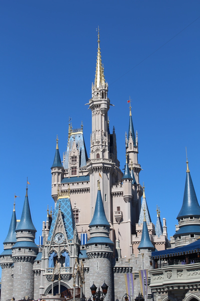 city, tower, spirituality, belief, day, architecture, building, gothic style, disney, place of worship, spire, ornate, travel destinations, clear sky, built structure