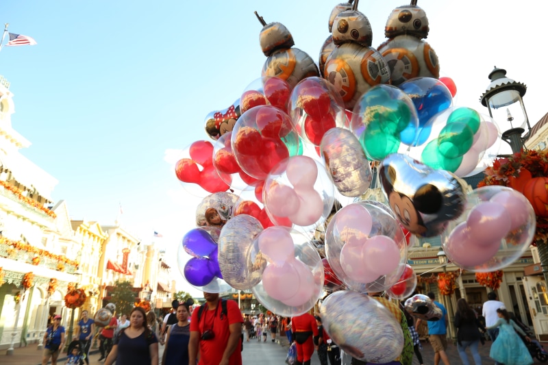 outdoors, lifestyles, sky, crowd, multi colored, festival, built structure, nature, building exterior, sunlight, balloons, balloon, adult, magic kingdom park
