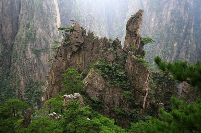 eroded, cypress, rock formation, geology, rock, huangshan, beauty in nature, cliff, solid, growth, tree, outdoors, nature, travel, daytime, mountain, non-urban scene