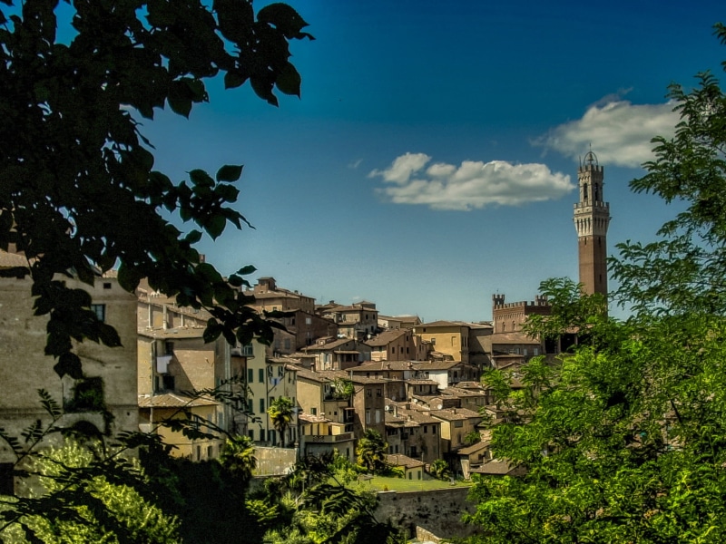 low angle view, building exterior, no people, town, nature, village, residential district, blue, architecture, cloud - sky, tall - high, day, painted, buildings