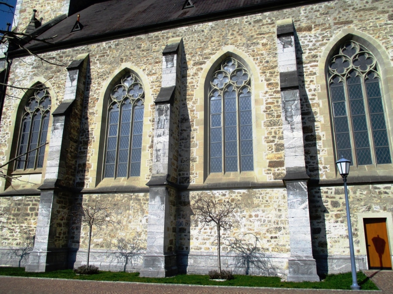 sunlight, history, architecture, facade, nature, day, place of worship, no people, the past, belief, low angle view, church of st florin, outdoors, building