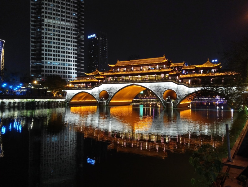 architecture, river, building exterior, arch bridge, travel destinations, no people, covered, bridge - man made structure, city, night, skyscraper, Anshun