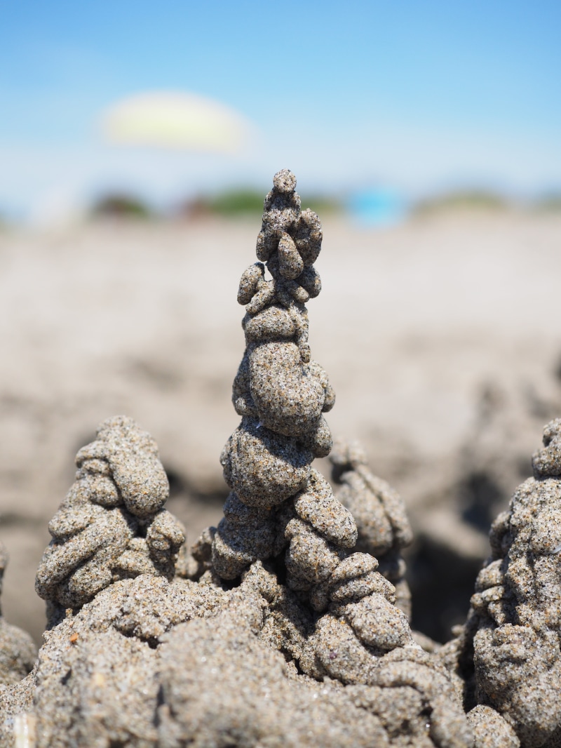 sea, sand, sand artwork, sandburg, outdoors, textured, 4K, balance, focus on foreground, towers, day, beach, surface level, close-up, nature, solid, holiday
