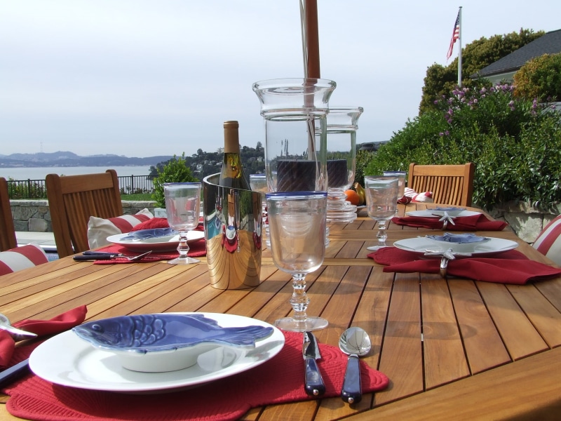 setting, no people, food and drink, plate, patio dining, picnic, Outdoor, table, dinnerware, teak, outside, refreshment, drink, wineglass, drinking glass