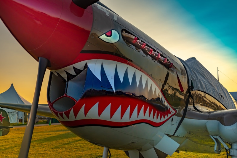 airplane, red, yellow, outdoors, aviation, ww2, low angle view, military, warbird, airshow, nautical vessel, multi colored, no people, sky, aircraft, mode of transportation