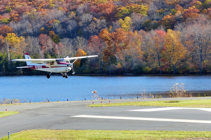 single, lake, air port, nautical vessel, outdoors, flying, personal aircraft, land, plant, tree, air planes, propeller aircraft, private airplane, day