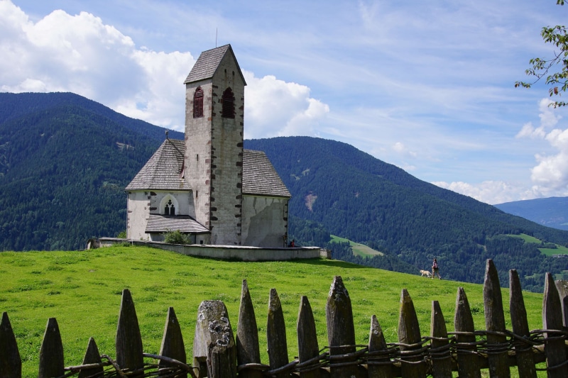 grass, dog, trees, green, daylight, church, nails, outdoors, girl, hill, clouds, high, landscape, hiking, architecture, funes, blue, adventure, summer