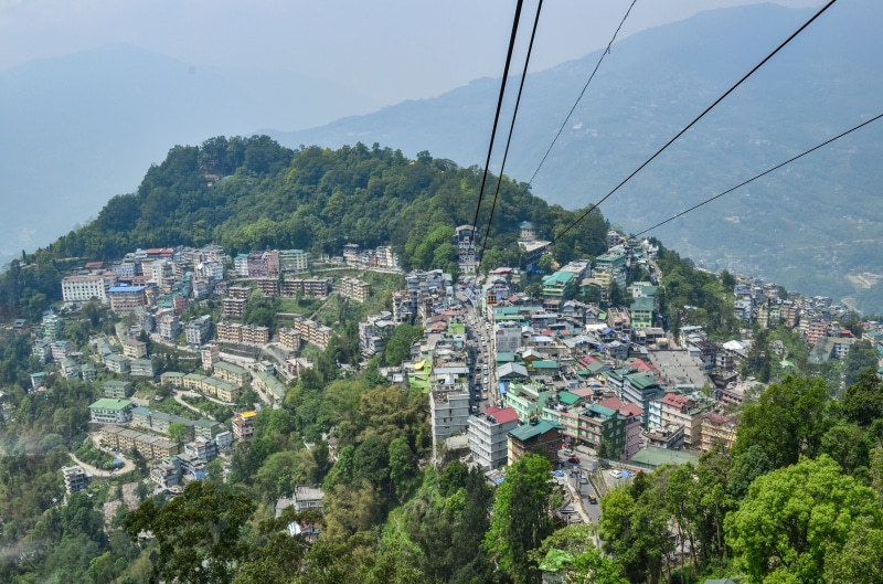 built structure, building, sky, holiday, overhead cable car, aerial, day, travel, rope-way, high, tree, tourism, sikkim, hill, architecture, high angle view