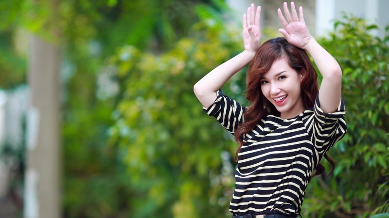 arms raised, one person, young women, beautiful girl woman images 1920x1080, outdoors, waist up, smiling, happiness, front view, casual clothing, striped