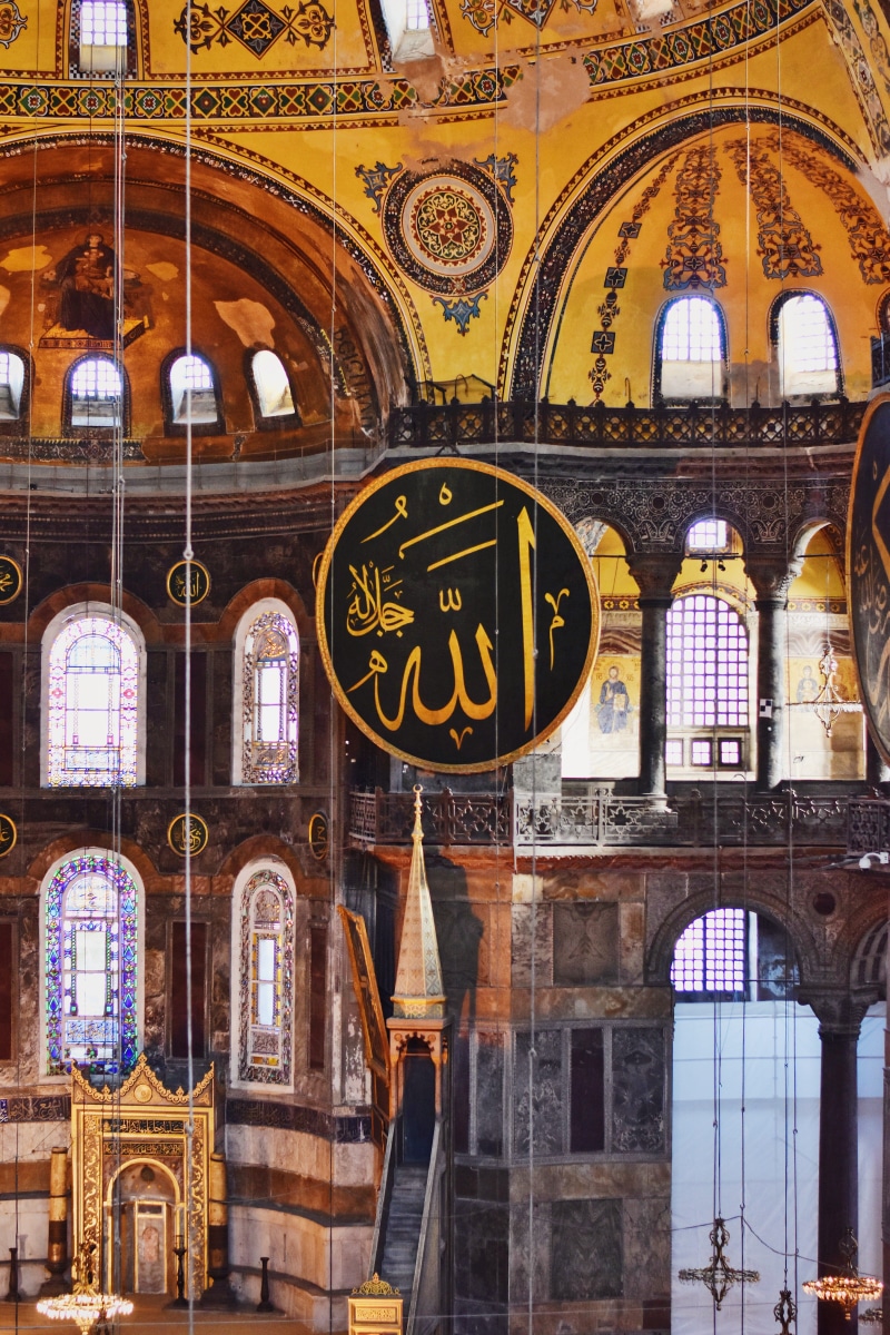 calligraphy, low angle view, window, spirituality, illuminated, ceiling, building exterior, no people, architecture, print, building, arch, text, travel