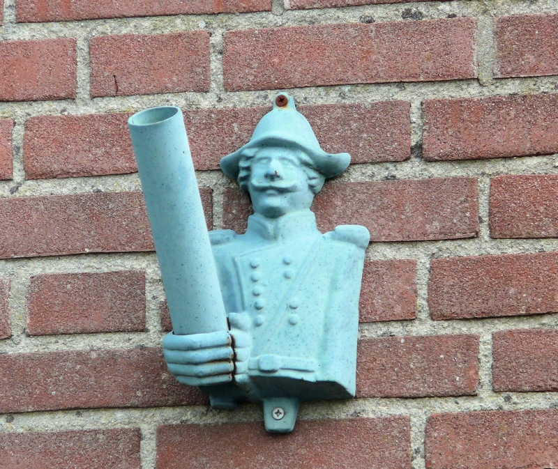 close-up, wall decoration, male likeness, architecture, sculpture, Holder, wall - building feature, art and craft, representation, flagpole holder, low angle view