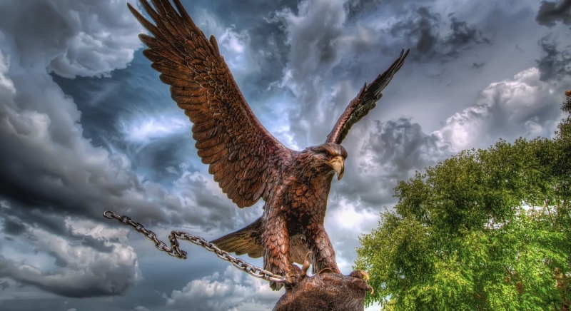 statue, cloud - sky, animals in the wild, Artistic, day, plant, nature, low angle view, animal wildlife, bird of prey, spread wings, animal body part, tree