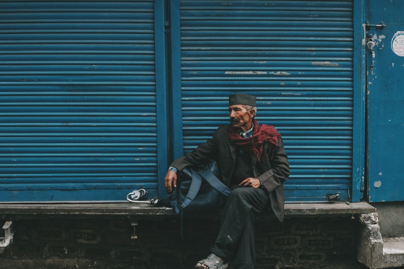 iron, backpack, clothing, closed, streetscape, concrete, metal, person, portrait, architecture, shutter, retro, wall, blue, casual clothing, gray, front
