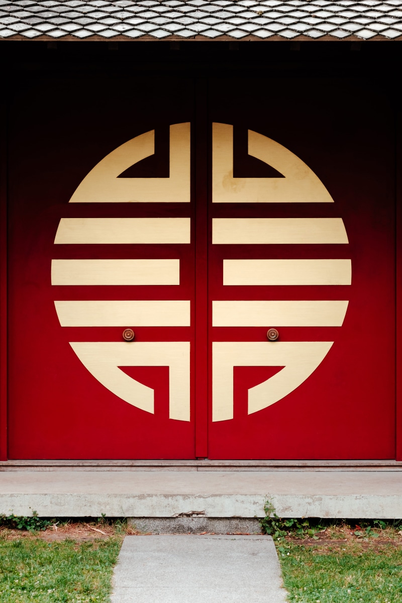 number, information, striped, wooden, indium, built structure, buddhist, golden, geometric shape, outdoors, wall - building feature, no people, red paint