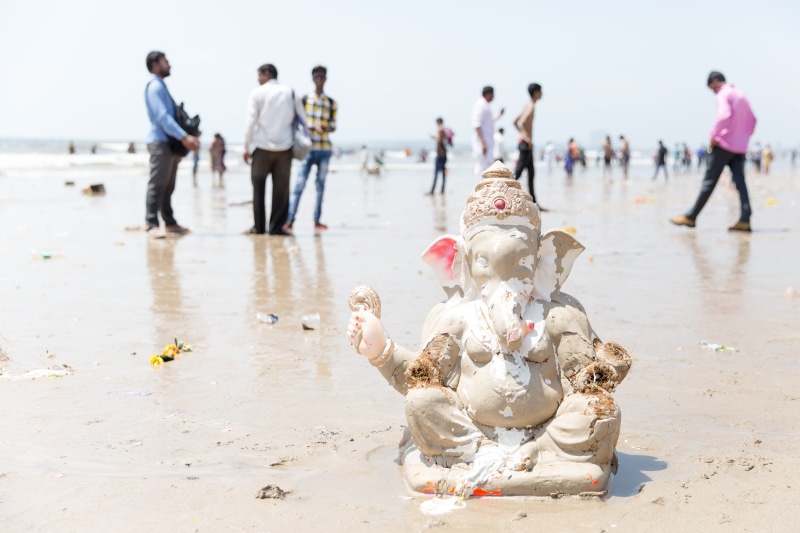 land, seashore, men, daytime, group, ceramic, ganesh, water, statue, large group of people, beach, group of people, near, crowd, women, ganesha, sand, focus on foreground