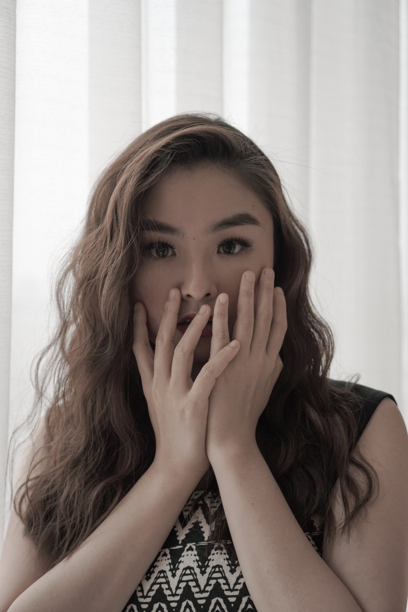hands covering mouth, hand, obscured face, girl, lifestyles, beautiful woman, young women, indoors, brunette, young adult, women, human face, girls, headshot