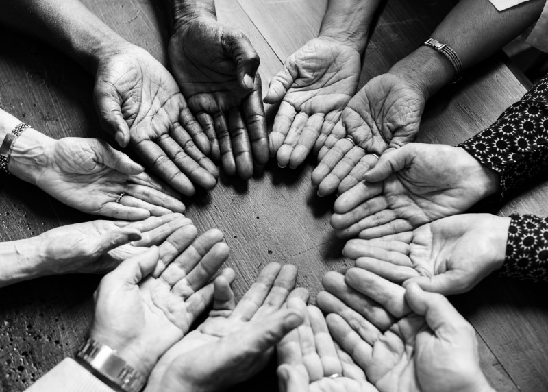 palms, together, day, directly above, group, grayscale, group of people, unrecognizable person, human hand, wooden table, finger, black and-white, care