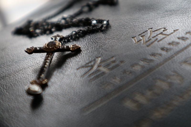 high angle view, close-up, prayer beads, rosary, art and craft, bible, still life, christian, worship, cross, antique, indoors, ornate, textile, studio shot