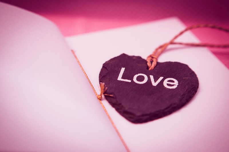 heart shape, close-up, indoors, gift, art, pink color, copy space, no people, message, communication, bookmark, shape, western script, heart, necklace