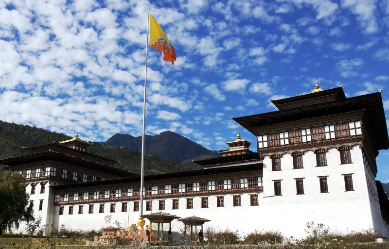cloud - sky, environment, faith, religion, hanged, pole, culture, oriental, outdoors, yellow, holy, day, building exterior, exotic, low angle view, mountain
