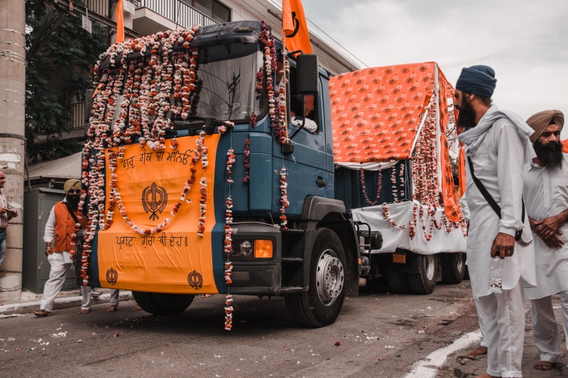 transportation, two, tarmac, tire, city, hindi, asphalt, occupation, apparel, standing, people, day, men, person, mode of transportation, orange color