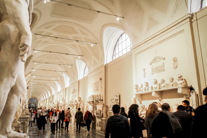 large group of people, lifestyles, exhibition, crowd, real people, religion, architectural column, bust, ceiling, people, tourism, architecture, museum