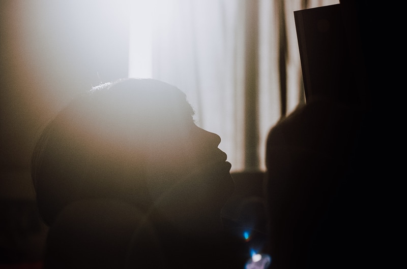 shot on film, 5K, togetherness, leisure activities, 35mm, indoors, finger, fog, sunlight, flare, sunrays, real people, child, reading, film photography