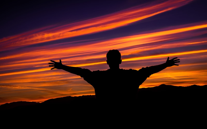freedom, red sky, beauty in nature, sideward, dance pose, arms raised, emotion, limb, human limb, worship, one person, real people, leisure activities