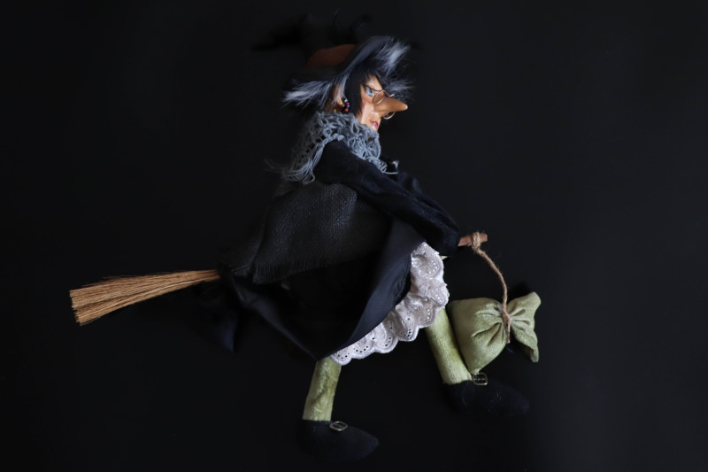 studio shot, witch, clothing, fun, full length, looking at camera, three quarter length, childhood, scary, portrait, young adult, costume, holding, baby doll
