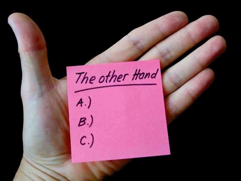 indoors, studio shot, human limb, close-up, note - message, unrecognizable person, human hand, black background, on the other hand, human finger, finger