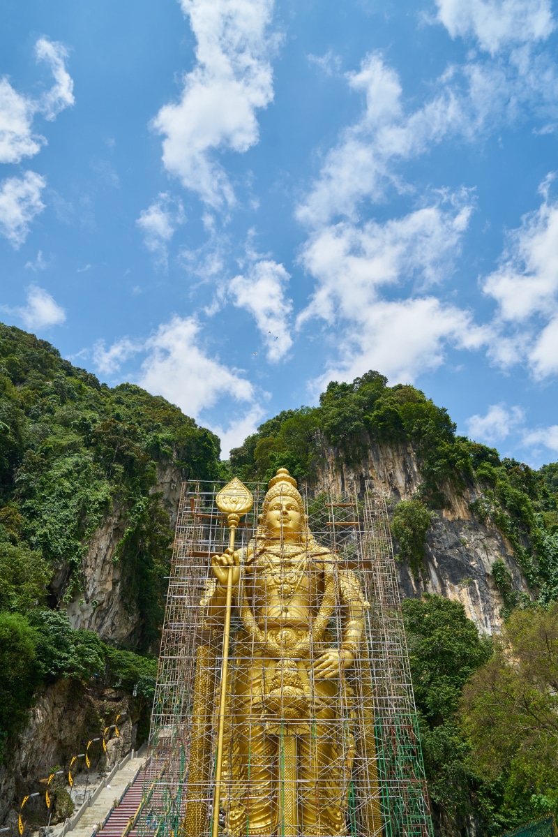 cloud - sky, rock - object, yellow, beauty in nature, sky, ancient civilization, buddhism, malaysia, travel destinations, nature, indian, aesthetics, statue