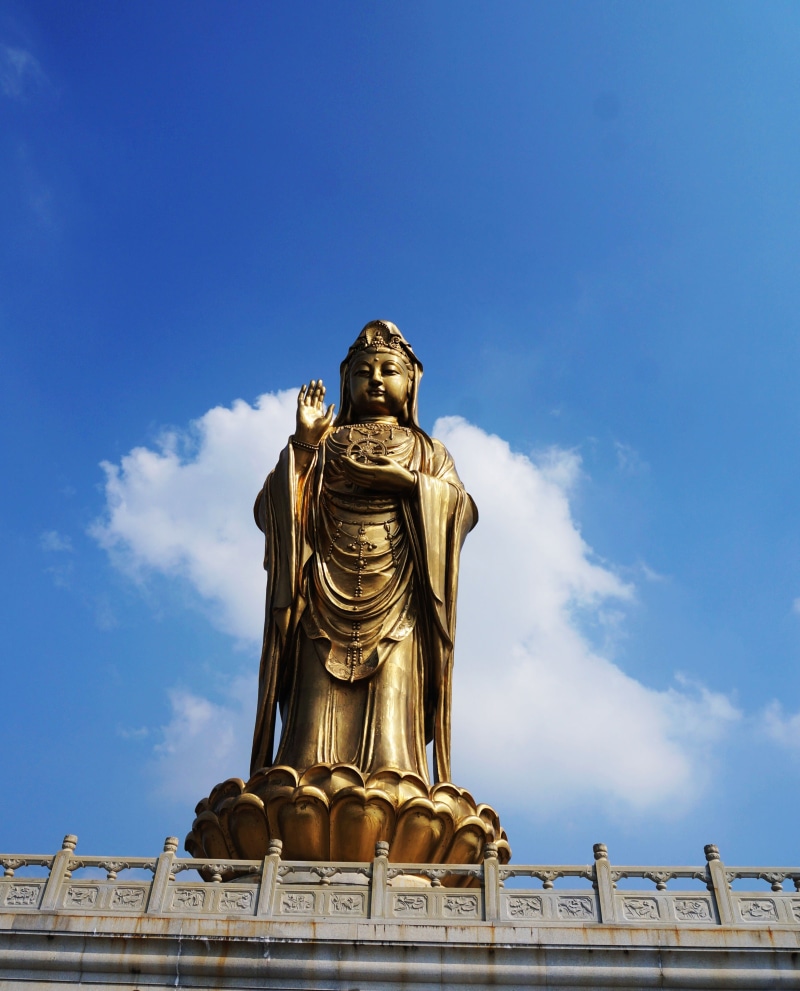 blue sky, sky, female likeness, blue, guanyin, putuo, art and craft, representation, religion, cloud - sky, human representation, day, statue, craft, spirituality